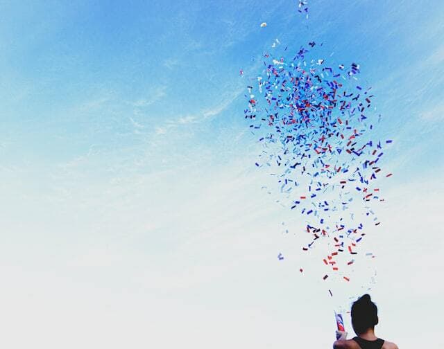 man shooting confetti in the air