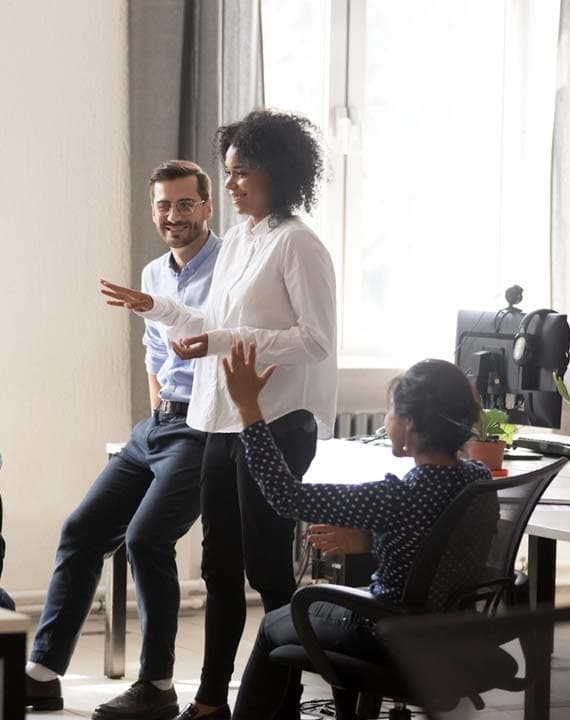 woman talking to coworkers in office