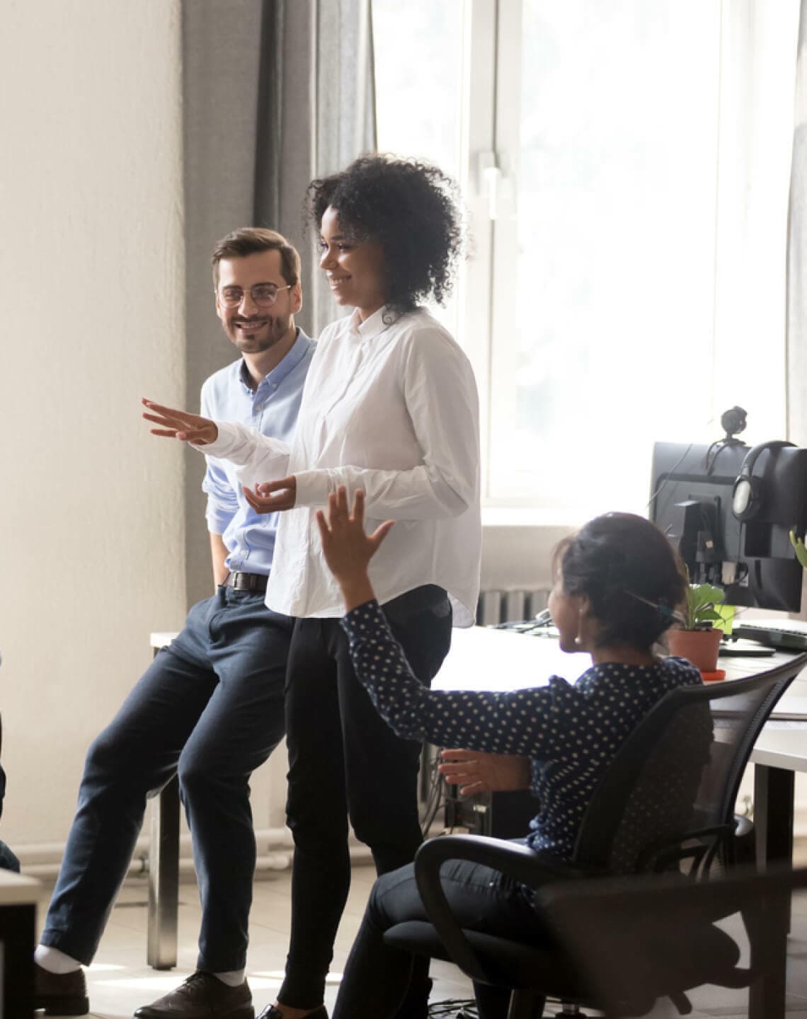 woman talking to coworkers in office